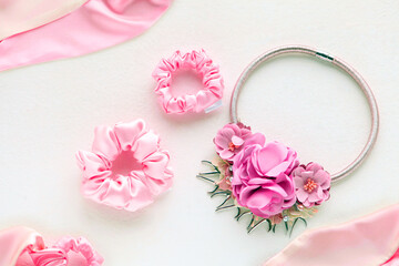 Pink hair accessories withroses. silk Pink Scrunchy isolated on white backdrop. Flat lay Hairdressing tools and accessories as Color Hair Scrunchies, Elastic HairBands, Bobble Scrunchie Hairband