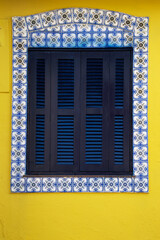 window of an old house adorned with Portuguese tiles in the historic center of Cananeia