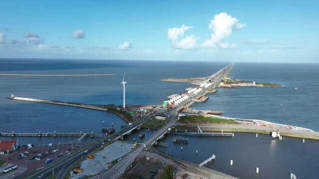 Afsluitdijk construction on pumping stations new sluices and the A7 near Den Oever, Kornwerderzand , and Zurich. Lock for shipping, road traffic cyclists and walkers. Aerial drone view.