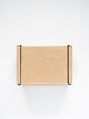 cardboard box on white table. packaging and delivery concept, top view