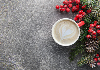 Obraz na płótnie Canvas Cup of latte coffee and Christmas decoration on a dark concrete background