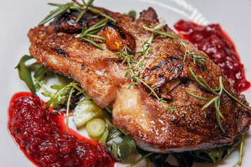 Sirloin steak with cranberry sauce and vegetable salad with thyme, rosemary and garlic
