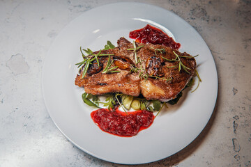 Sirloin steak with cranberry sauce and vegetable salad with thyme, rosemary and garlic