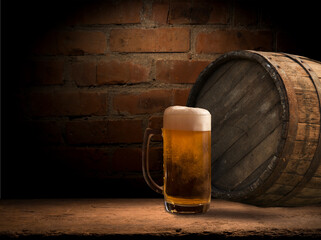 Oktoberfest beer barrel and beer glasses with wheat and hops on wooden table. High quality photo