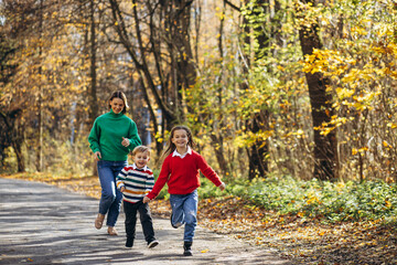 Fototapeta premium Mother with children walking in park