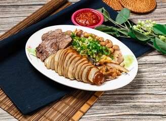 Chinese Mixed platter medium with beef, pork sliced, beans, green onion and chili sauce served in a bowl isolated on table top view of taiwanese food