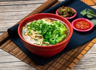 Yangchun noodles with green onion and chili sauce served in a bowl isolated on table top view of taiwanese food