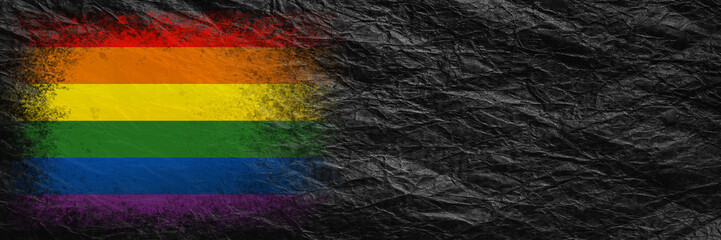 Flag of LGBT. Flag is painted on black crumpled paper. Paper background. Copy space. Textured background