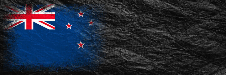 Flag of New Zealand. Flag is painted on black crumpled paper. Paper background. Copy space. Textured background