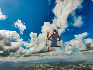 Women on a swing in the sky