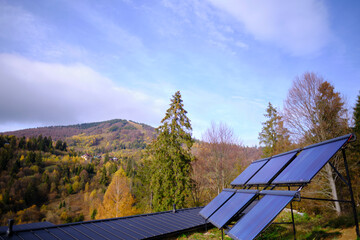 Fototapeta na wymiar The solar water collector for heating water is located in the mountains. Autumn season