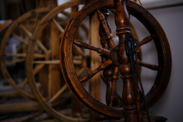 Wooden spinning wheel. The traditional method of making woolen threads