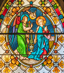 BIELLA, ITALY - JULY 15, 2022: The Annunciation in the stained glass of Duomo from 19. cent.