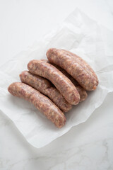 uncooked bbq sausage top view food on white paper