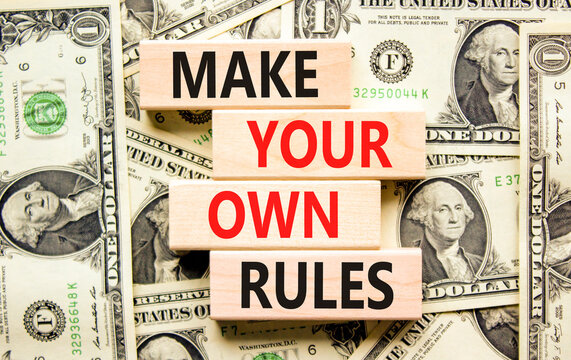 Make your own rules symbol. Concept words Make your own rules on wooden cubes. Beautiful background from dollar bills. Business motivational make your own rules concept. Copy space