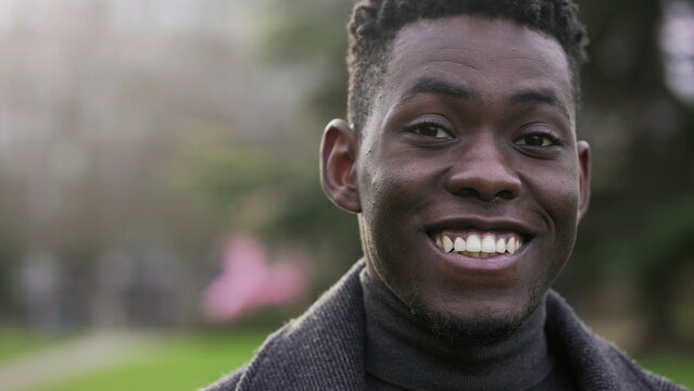 Handsome black African man smiling outside during daylight