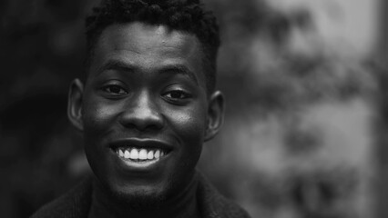 Happy African man smiling at camera, black and white monochrome