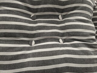striped decorative pillow with buttons for background
