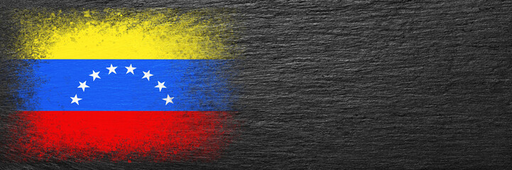 Flag of Venezuela. Flag is painted on black slate stone. Stone background. Copy space. Textured background