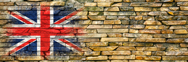 Flag of Britain. Flag is painted on a stone wall. Stone background. Copy space. Textured background