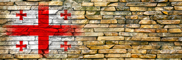 Flag of Georgia. Flag is painted on a stone wall. Stone background. Copy space. Textured background