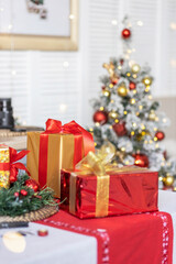 Packed boxes with Christmas gifts on the background of a festive tree