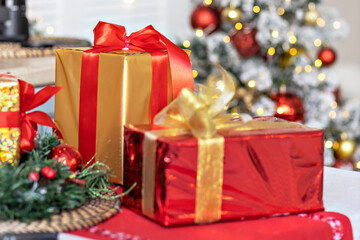 Fototapeta na wymiar Packed boxes with Christmas gifts on the background of a festive tree