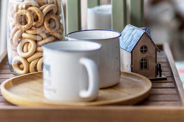 Morning Christmas coffee with marshmallows and Christmas decorations on a tray table by the window on the windowsill