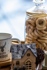 Morning Christmas coffee with marshmallows and Christmas decorations on a tray table by the window on the windowsill