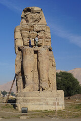 Luxor, Egypt: Men work to restore one of the Colossi of Memnon (1350 BC), a massive statue of Amenhotep III, who reigned during the 13th Dynasty.