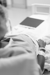 A pregnant woman in labor, lying in a hospital bed waiting for her baby to be born.