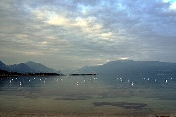buoys on water, island and mountains at Lake Garda