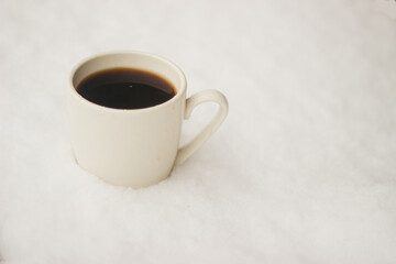 a cup of coffee in the snow