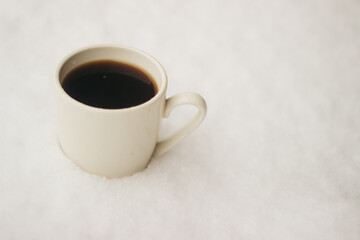 a cup of coffee in the snow