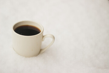 a cup of coffee in the snow