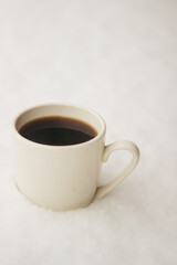 a cup of coffee in the snow