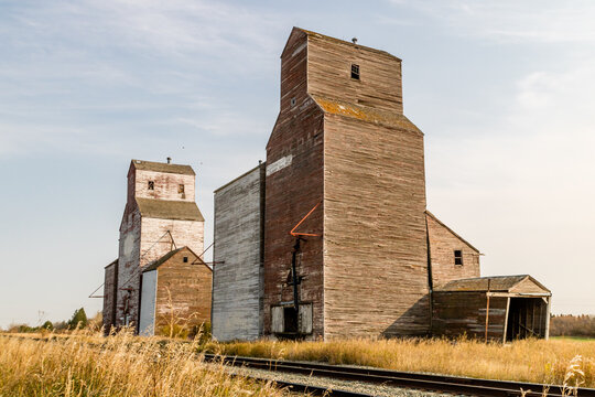 Three red and white grain eleavotrs and trains. Waseca, Saskatchewan, Canada