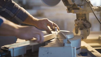 The carpenter cuts wood with a chainsaw.
Carpenter is cutting wood with electric circular saw.
