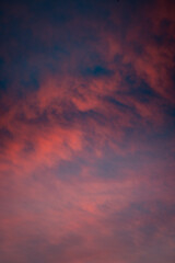 Red clouds on a dramatic colorful cold winter sunset sky, warm tones, Germany, Europe