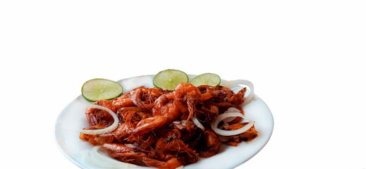 Plate of fried shrimp with onions and lemon on white background with copy space