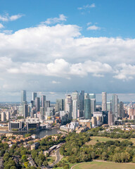 London, the city on the river bank, with residential buildings, green areas, and modern skyscrapers, aerial view.
