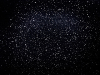 Fototapeta premium Blurred dots on black background. Dark texture with particles