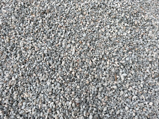 Isolated small many crushed stone ground floor background. Natural granite gravel texture