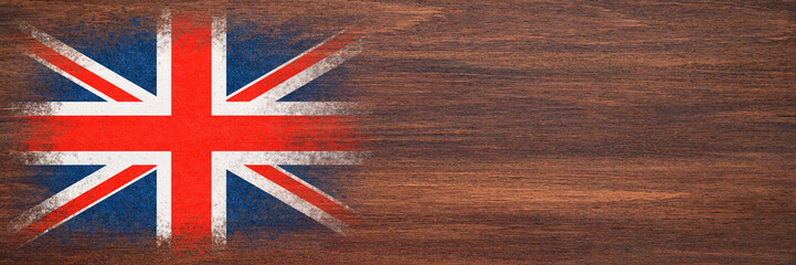 Flag of Britain. Flag is painted on a wooden surface. Wooden background. Plywood surface. Copy space. Textured background