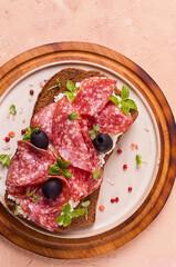 Sandwich , grain bread, with cream cheese and salami, black olives, micro-greens, top view, close-up, no people, Breakfast,