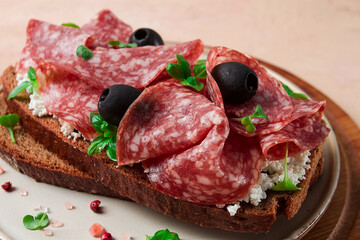 Sandwich , grain bread, with cream cheese and salami, black olives, micro-greens, top view, close-up, no people, Breakfast,