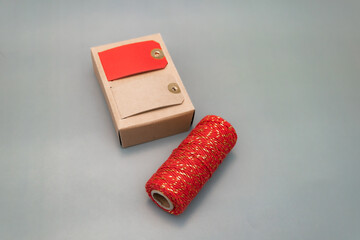  red ribbon and name tags for wrapping New Year's gifts. cotton red ribbon with golden inserts. place for text, christmas atmosphere, new year, gifts, family, holiday