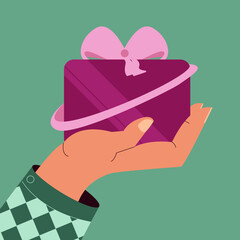 hand holding purple gift with pink ribbon