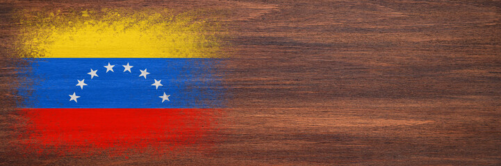 Flag of Venezuela. Flag is painted on a wooden surface. Wooden background. Plywood surface. Copy space. Textured background