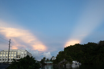 Unique natural phenomena in Palau.  The setting sun is reflected in the clouds on the other side and the light strech out in the sky.